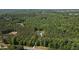 Far aerial view of the new construction home nestled in mature forest at 130 West Lake Blvd, Carrollton, GA 30116