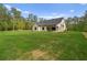A large backyard featuring a well-manicured lawn and a covered patio at 130 West Lake Blvd, Carrollton, GA 30116