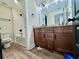 Bathroom featuring modern fixtures, double vanity with granite countertop, and a shower-tub combo, blending style and function at 130 West Lake Blvd, Carrollton, GA 30116