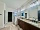 Bathroom featuring double vanity, granite countertops, tiled walk-in shower, soaking tub, and modern fixtures at 130 West Lake Blvd, Carrollton, GA 30116