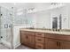 Modern bathroom featuring a double vanity with granite countertops and a luxurious glass shower at 130 West Lake Blvd, Carrollton, GA 30116