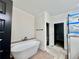 Bathroom featuring a soaking tub with modern fixtures, a tiled walk-in shower, and granite countertops at 130 West Lake Blvd, Carrollton, GA 30116