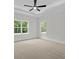 Spacious bedroom featuring a modern ceiling fan, plush carpet, and lots of natural light from the two windows at 130 West Lake Blvd, Carrollton, GA 30116
