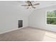 Bright bedroom with a window, ceiling fan, and light colored carpet and walls at 130 West Lake Blvd, Carrollton, GA 30116