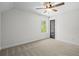 Neutral bedroom featuring a ceiling fan, a window providing ample natural light, and plush carpet at 130 West Lake Blvd, Carrollton, GA 30116