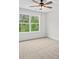 A bedroom filled with natural light and featuring a ceiling fan and neutral walls and carpet at 130 West Lake Blvd, Carrollton, GA 30116