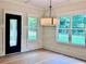 Dining area with decorative chandelier, modern trim, large windows, and a backyard view at 130 West Lake Blvd, Carrollton, GA 30116
