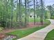 Scenic driveway surrounded by lush greenery, leading to a private and secluded residence at 130 West Lake Blvd, Carrollton, GA 30116