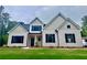 New construction home with traditional architecture, black shutters, neutral siding, and well-maintained lawn at 130 West Lake Blvd, Carrollton, GA 30116
