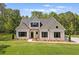 Charming home featuring a well-manicured lawn and neutral exterior with black shutters at 130 West Lake Blvd, Carrollton, GA 30116