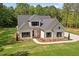 New home with craftsman style architecture, manicured lawn and trees, and side entry garage at 130 West Lake Blvd, Carrollton, GA 30116
