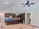 Spacious kitchen design with island, pendant lights, dark wood cabinetry, vaulted ceilings and stainless appliances at 130 West Lake Blvd, Carrollton, GA 30116