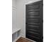Convenient mudroom area with built-in bench, storage, and a stylish black door at 130 West Lake Blvd, Carrollton, GA 30116