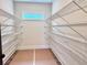 Walk-in pantry featuring wire shelving, accent window, and ample storage space at 130 West Lake Blvd, Carrollton, GA 30116