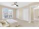 Bedroom featuring large windows and a ceiling fan, complete with closet storage at 2657 Lenox Ne Rd # A-9, Atlanta, GA 30324