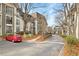 Exterior of condo building with parking, landscaping, and trees on a sunny day at 2657 Lenox Ne Rd # A-9, Atlanta, GA 30324