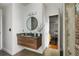 Modern bathroom with floating vanity, round mirror, and stylish decor with easy access to storage and the doorway at 3235 Roswell Ne Rd # 617, Atlanta, GA 30305