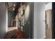 Hallway features an eclectic art collection, track lighting, and a decorative rug at 3235 Roswell Ne Rd # 617, Atlanta, GA 30305