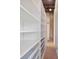 Bright hallway features built-in white shelving and unique tile flooring, with exposed concrete architecture at 3235 Roswell Ne Rd # 617, Atlanta, GA 30305