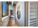 Hallway with hardwood floors, exposed brick, and modern decor at 3235 Roswell Ne Rd # 617, Atlanta, GA 30305