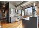 Contemporary kitchen featuring stainless steel appliances, granite countertops, and exposed brick wall at 3235 Roswell Ne Rd # 617, Atlanta, GA 30305