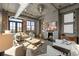 Comfortable living room featuring a fireplace, exposed brick, and ample seating at 3235 Roswell Ne Rd # 617, Atlanta, GA 30305