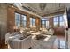 Bright living room with exposed brick, industrial-style ceiling, large windows, and comfortable seating at 3235 Roswell Ne Rd # 617, Atlanta, GA 30305