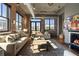 Stylish living room with exposed brick, fireplace, and large windows offering plenty of natural light at 3235 Roswell Ne Rd # 617, Atlanta, GA 30305