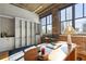 Beautiful office featuring exposed brick, hardwood floors, built-in shelves, large windows and modern decor at 3235 Roswell Ne Rd # 617, Atlanta, GA 30305