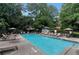 Community pool with lounge chairs, umbrellas, and a covered gazebo at 3235 Roswell Ne Rd # 617, Atlanta, GA 30305