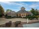 Exterior view of the community center with manicured landscaping and covered seating at 4130 Summit Gate Dr, Suwanee, GA 30024