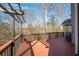 Wooden deck with a pergola, railing, grill, and wooded views at 4130 Summit Gate Dr, Suwanee, GA 30024