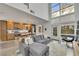 Open living area with L-shaped sectional sofa, modern kitchen, and high ceilings at 1213 Van Allen Nw Mews # 47, Atlanta, GA 30318