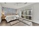 Bright bedroom with a king-size bed, dark hardwood floors, and unique wall decor at 1213 Van Allen Nw Mews # 47, Atlanta, GA 30318