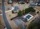 A high angle view shows the home with an in-ground pool, pool house, large yard, and mature trees at 6310 Talking Tree Ct, Cumming, GA 30028