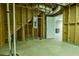 Unfinished basement with electrical panel and exposed studs at 6310 Talking Tree Ct, Cumming, GA 30028
