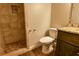 Tiled bathroom with modern toilet, vanity with granite countertop, and tiled shower stall at 6310 Talking Tree Ct, Cumming, GA 30028