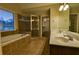 Bathroom with a soaking tub and glass-enclosed shower at 6310 Talking Tree Ct, Cumming, GA 30028