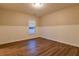 Bedroom featuring wood floors, wainscoting, and a window with blinds at 6310 Talking Tree Ct, Cumming, GA 30028