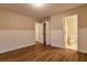 Bedroom highlighting wood-look floors, wainscoting, and en suite bathroom at 6310 Talking Tree Ct, Cumming, GA 30028