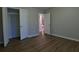 Bedroom showcasing wood-look floors, neutral walls, and an open closet at 6310 Talking Tree Ct, Cumming, GA 30028