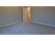 View of bedroom with neutral carpet, walls, and doorway leading to hallway at 6310 Talking Tree Ct, Cumming, GA 30028