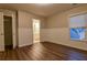 Bedroom with wood-look flooring, wainscoting, and access to the bathroom at 6310 Talking Tree Ct, Cumming, GA 30028