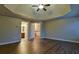 Large bedroom with tray ceilings, wood floors, and natural light at 6310 Talking Tree Ct, Cumming, GA 30028