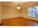 Bright dining room with large windows, hardwood floors, and classic wainscoting at 6310 Talking Tree Ct, Cumming, GA 30028