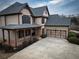 Beautiful two-story home with a two-car garage and covered porch at 6310 Talking Tree Ct, Cumming, GA 30028