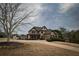 Charming two-story home with a well-manicured lawn and mature trees at 6310 Talking Tree Ct, Cumming, GA 30028