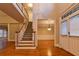Spacious foyer with hardwood floors, staircase, and an elegant chandelier at 6310 Talking Tree Ct, Cumming, GA 30028