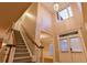 Elegant foyer with high ceilings, a staircase, and natural light from a window above at 6310 Talking Tree Ct, Cumming, GA 30028