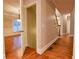 Entryway with hardwood floors, open doorway to room with window, and view of staircase at 6310 Talking Tree Ct, Cumming, GA 30028